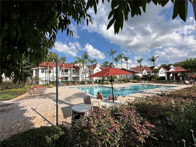 11538 Westwood Blvd Unit 226, Orlando, FL 32821 - community pool featuring a patio area and a residential view