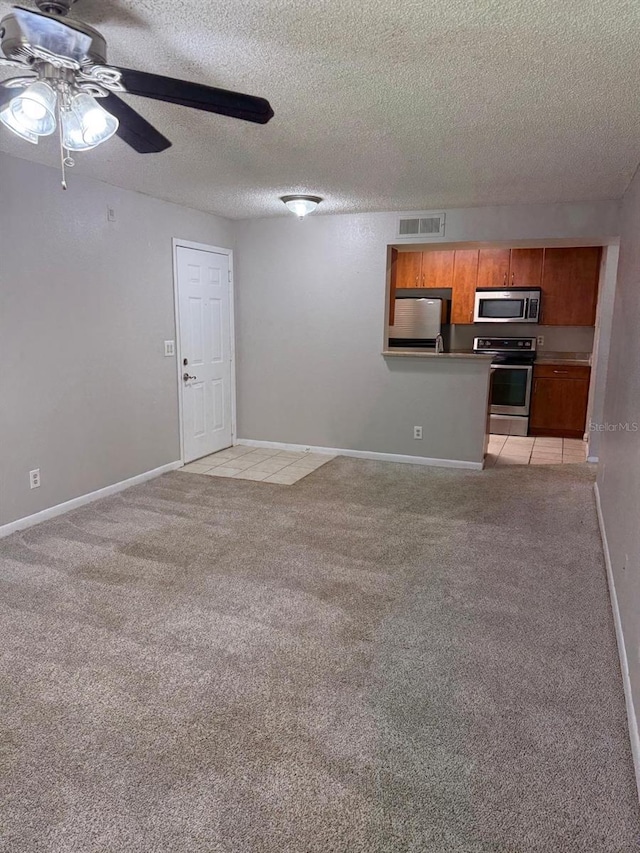 11538 Westwood Blvd Unit 226, Orlando, FL 32821 - unfurnished living room featuring light colored carpet, ceiling fan, and a textured ceiling