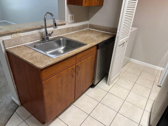11538 Westwood Blvd Unit 226, Orlando, FL 32821 - kitchen featuring stainless steel dishwasher, light tile patterned flooring, light countertops, and brown cabinets