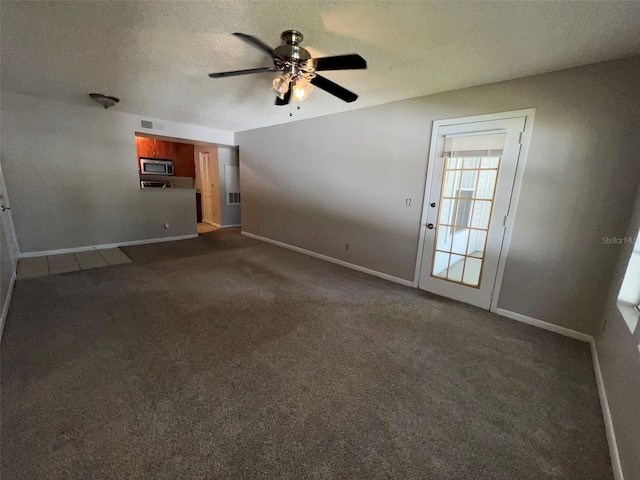 11538 Westwood Blvd Unit 226, Orlando, FL 32821 - unfurnished living room featuring dark carpet, a ceiling fan, and a textured ceiling