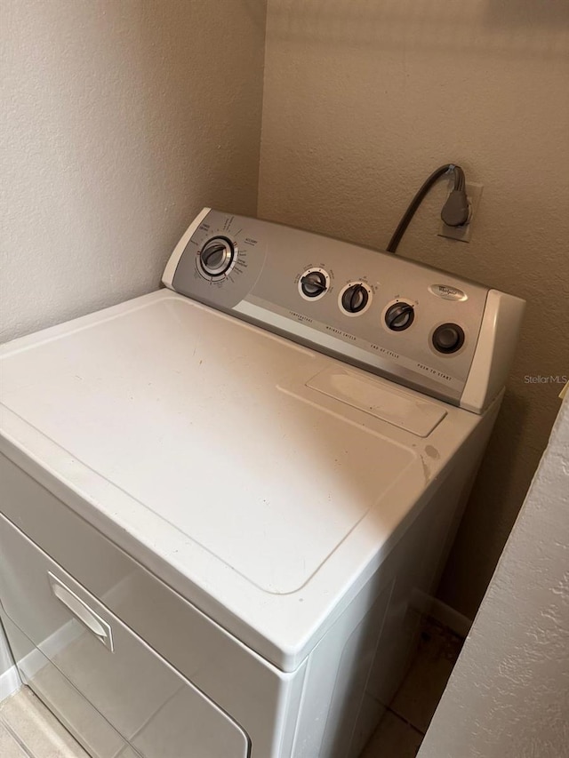 11538 Westwood Blvd Unit 226, Orlando, FL 32821 - washroom with washer / clothes dryer and a textured wall