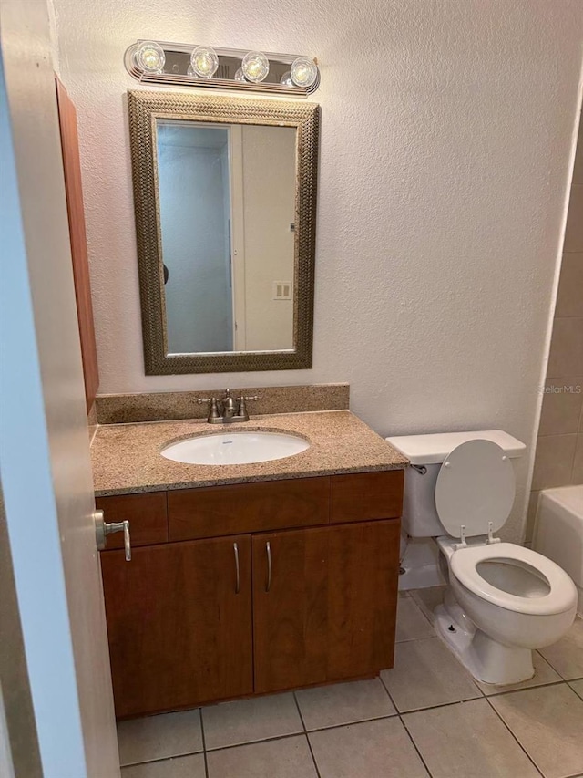 11538 Westwood Blvd Unit 226, Orlando, FL 32821 - bathroom featuring vanity, tile patterned floors, a textured wall, and a bathtub