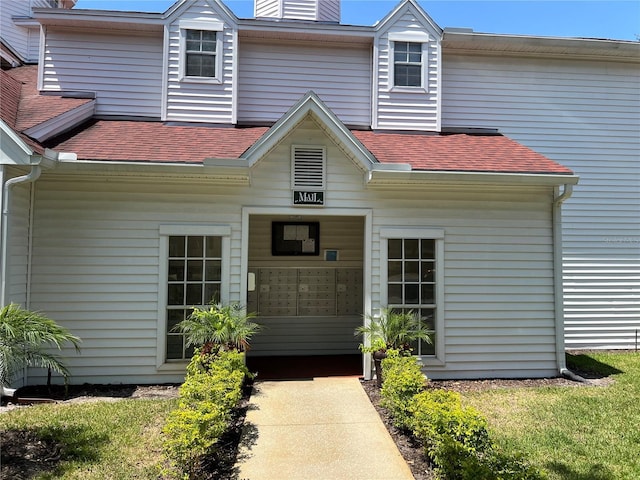 11538 Westwood Blvd Unit 226, Orlando, FL 32821 - view of exterior entry with a chimney and a shingled roof