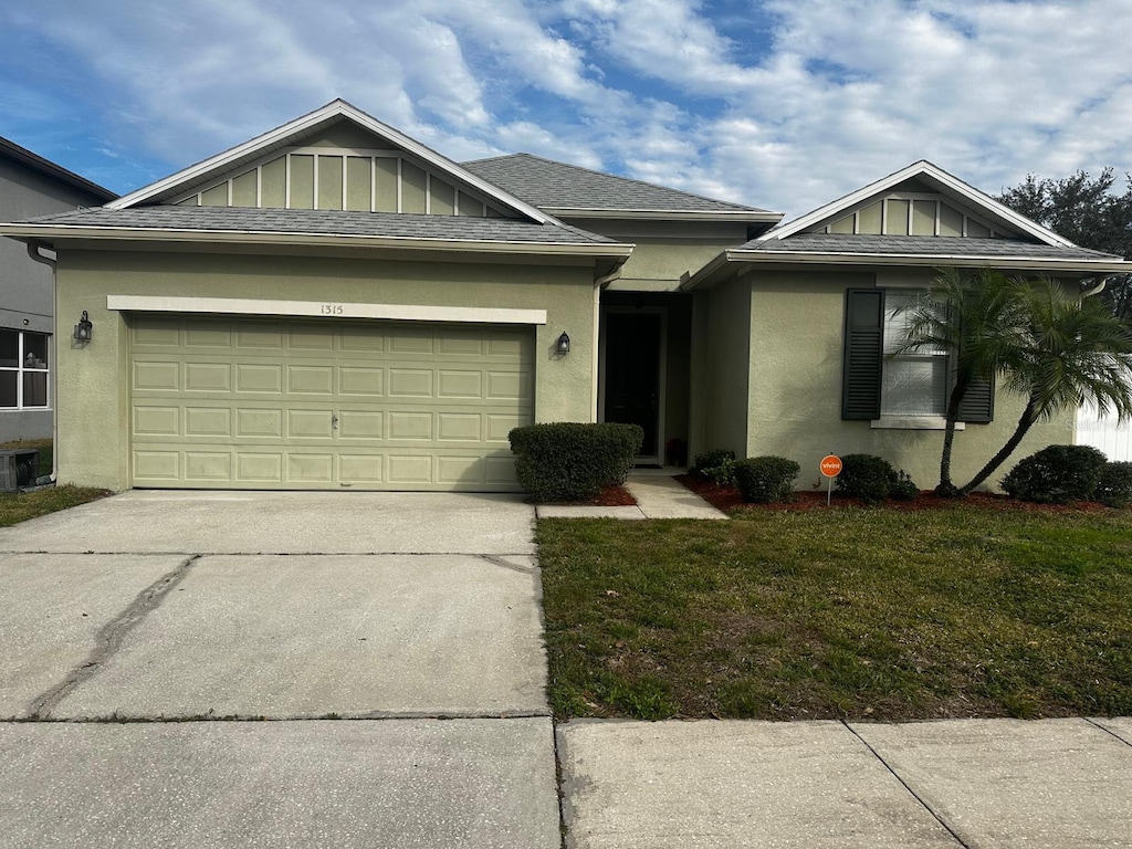 view of front of property with a front lawn and a garage