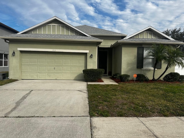 view of front of property with a front lawn and a garage