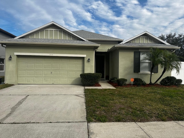 view of front of house with a garage and a front lawn