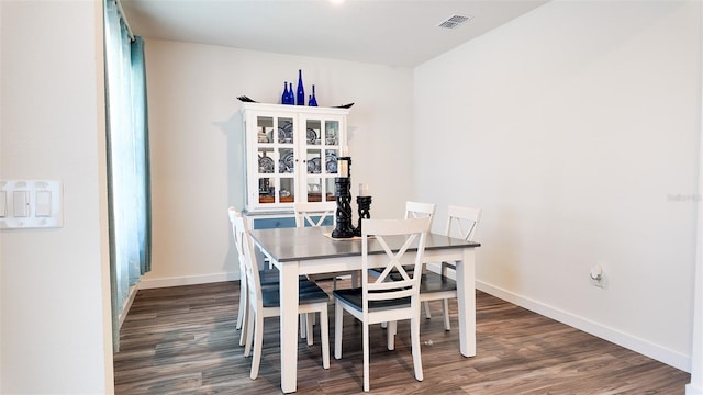 dining area featuring dark hardwood / wood-style floors