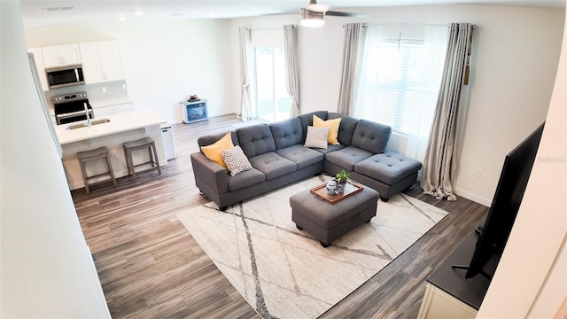 living room with sink and hardwood / wood-style floors