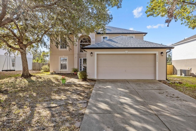 view of front of house featuring a garage and central air condition unit