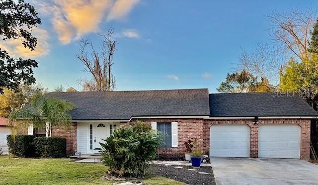 ranch-style home with a front yard and a garage