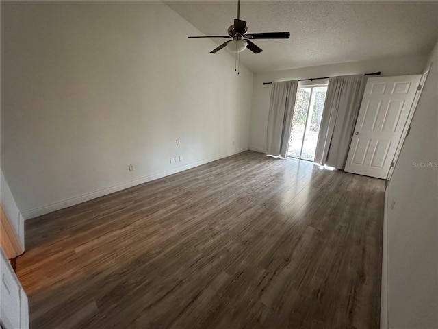 empty room featuring a textured ceiling, ceiling fan, dark hardwood / wood-style floors, and lofted ceiling