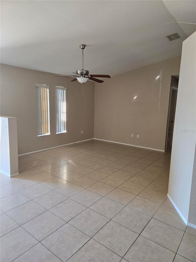 unfurnished room with ceiling fan and light tile patterned flooring