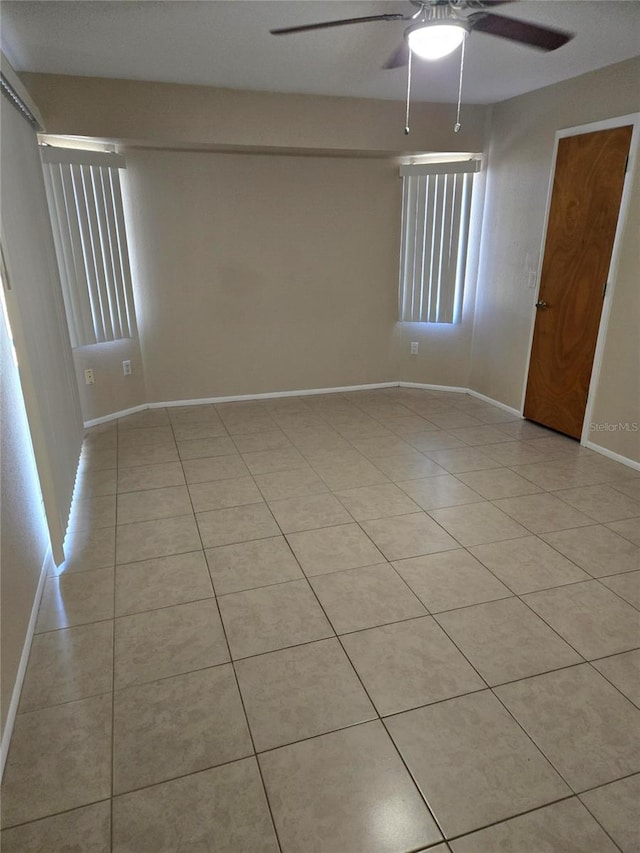 empty room with light tile patterned floors and ceiling fan