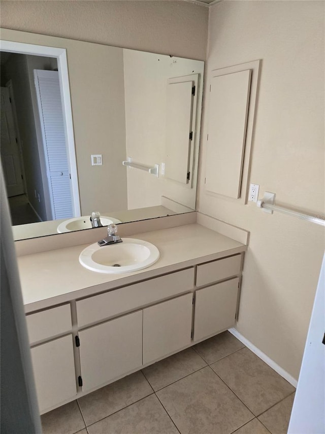 bathroom with tile patterned flooring and vanity