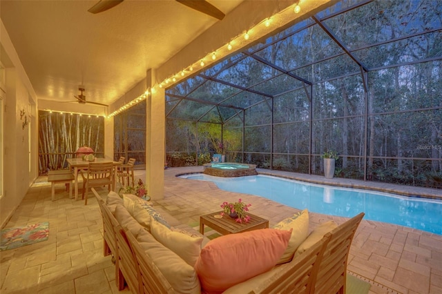 view of pool featuring a lanai, ceiling fan, a patio area, an outdoor hangout area, and an in ground hot tub