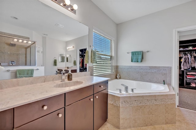 bathroom featuring vanity and shower with separate bathtub