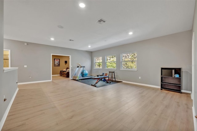 workout area with light hardwood / wood-style floors