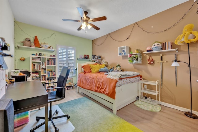 bedroom with ceiling fan and light hardwood / wood-style flooring