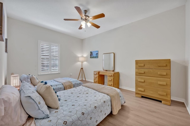 bedroom with ceiling fan and light hardwood / wood-style flooring