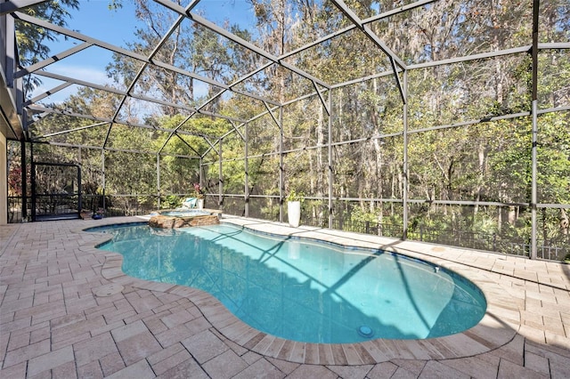 view of swimming pool with a patio, a lanai, and an in ground hot tub