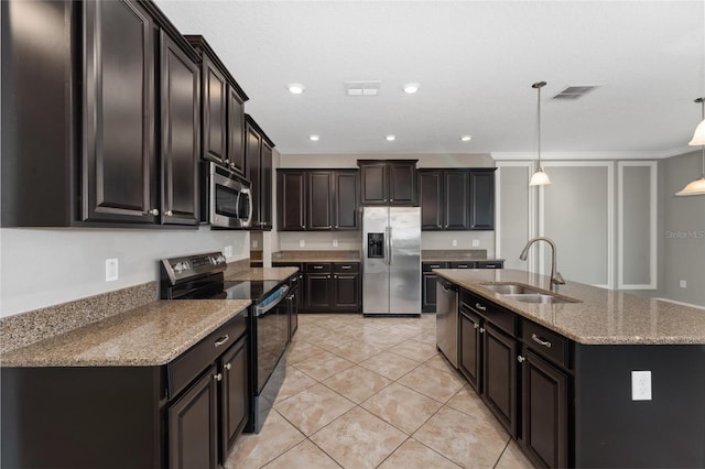 kitchen with stainless steel appliances, sink, an island with sink, hanging light fixtures, and light tile patterned flooring