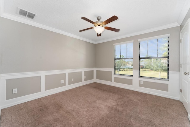 carpeted empty room featuring crown molding, ceiling fan, and a textured ceiling