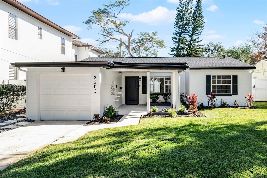 view of front of property with a front lawn and a garage