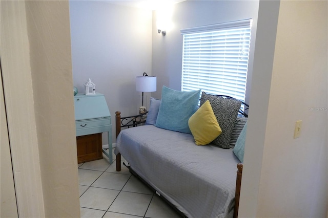 tiled bedroom with a baseboard heating unit