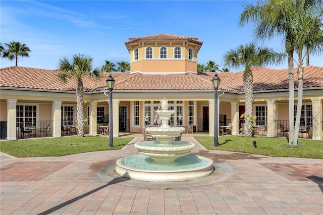 rear view of property with a lawn