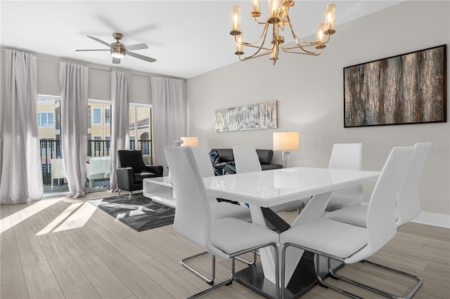 dining area featuring ceiling fan with notable chandelier and light wood-type flooring