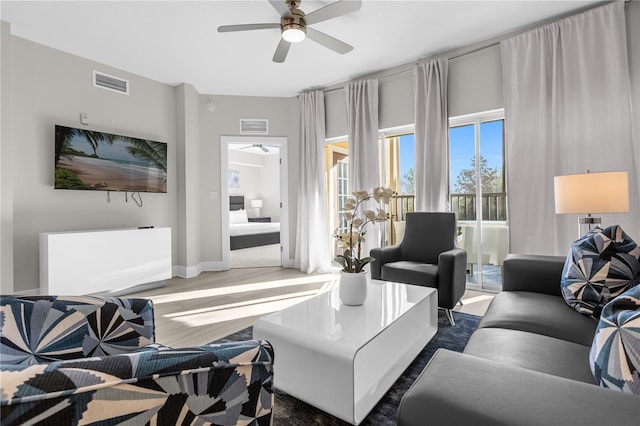 living room featuring hardwood / wood-style flooring and ceiling fan