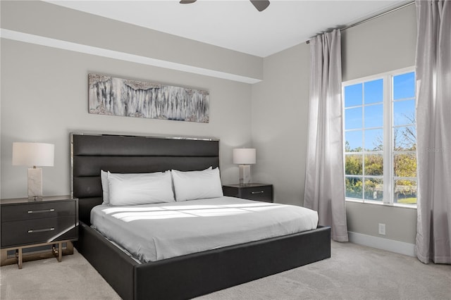 bedroom featuring ceiling fan and light carpet