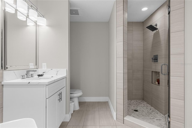 bathroom with tile patterned floors, vanity, toilet, and walk in shower