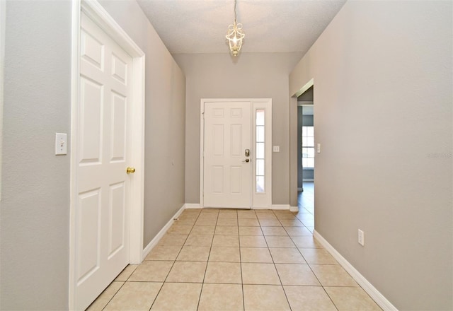 tiled foyer featuring a textured ceiling