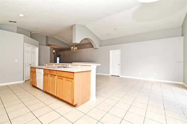 kitchen with white dishwasher, vaulted ceiling, a kitchen island with sink, a chandelier, and light tile patterned flooring