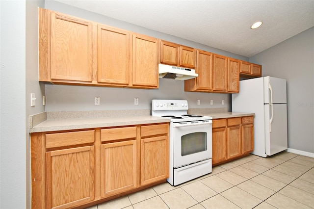 kitchen with light tile patterned floors and white appliances