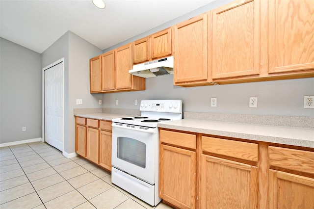 kitchen featuring light tile patterned floors, white electric stove, and light brown cabinetry