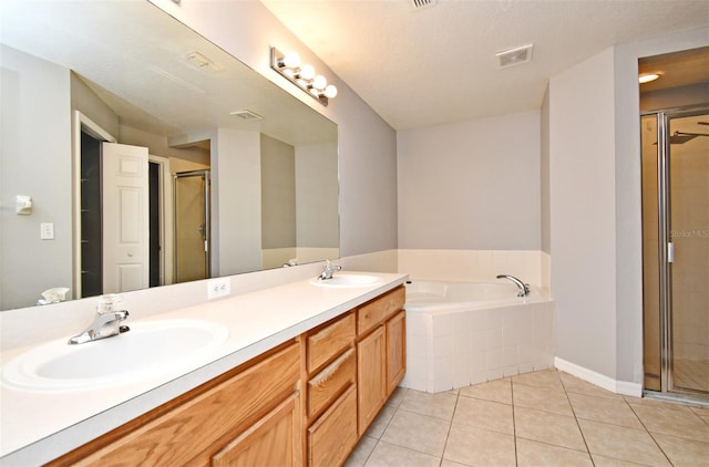 bathroom featuring tile patterned flooring, vanity, and separate shower and tub