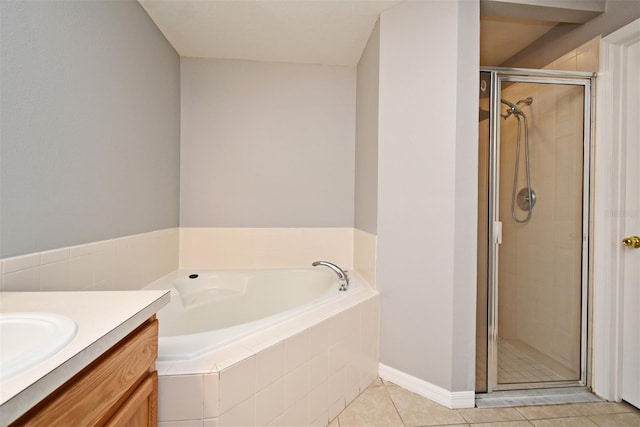 bathroom featuring tile patterned flooring, vanity, and separate shower and tub