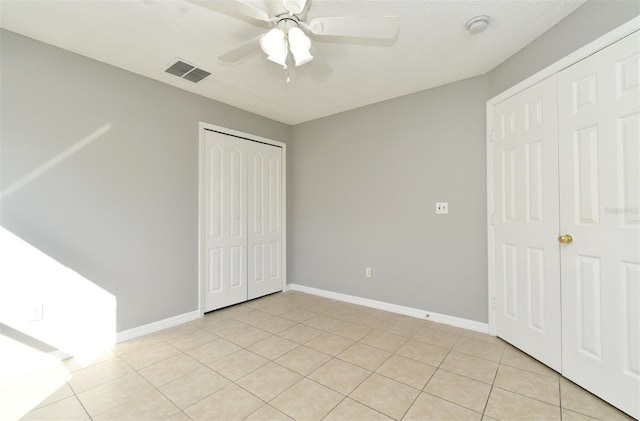 unfurnished bedroom featuring light tile patterned floors and ceiling fan