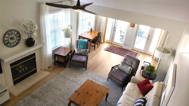 interior space featuring ceiling fan, a fireplace, and hardwood / wood-style flooring