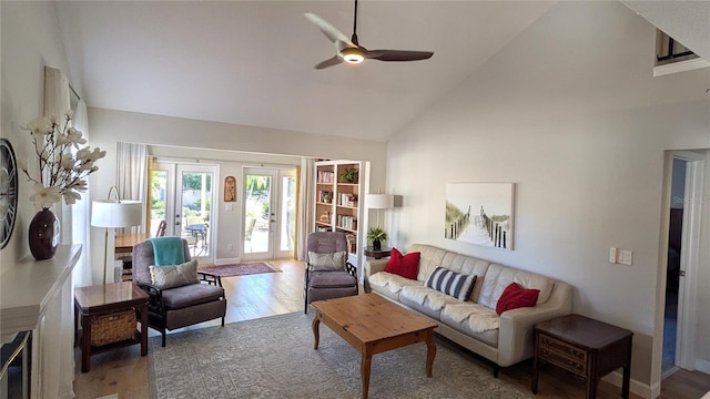 living room with ceiling fan, french doors, high vaulted ceiling, and hardwood / wood-style floors