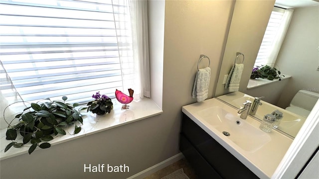 bathroom featuring vanity and toilet