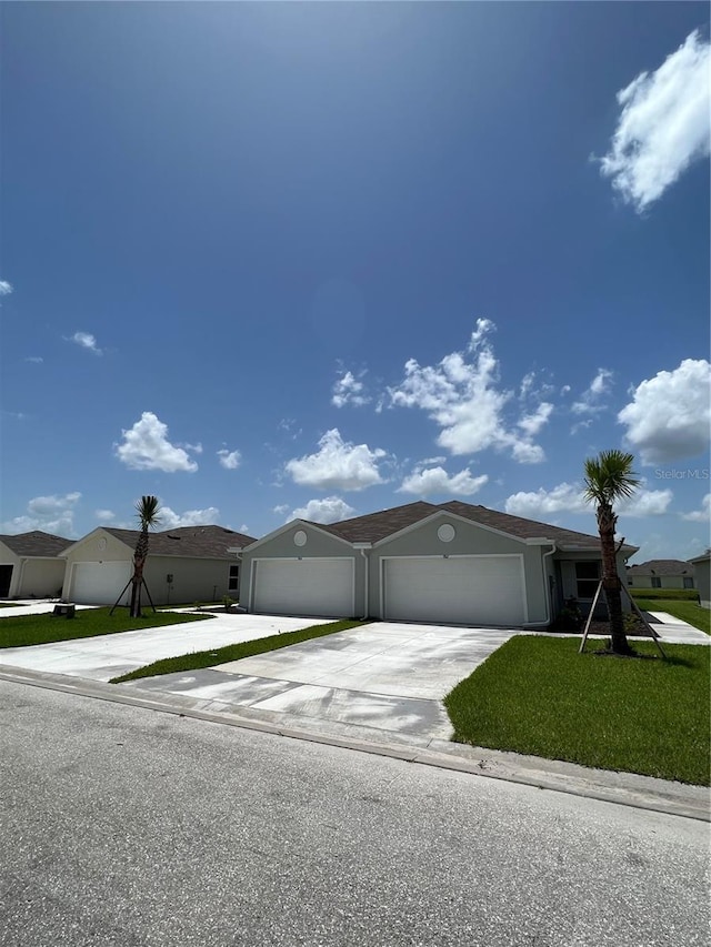 view of front of property with a front yard and a garage