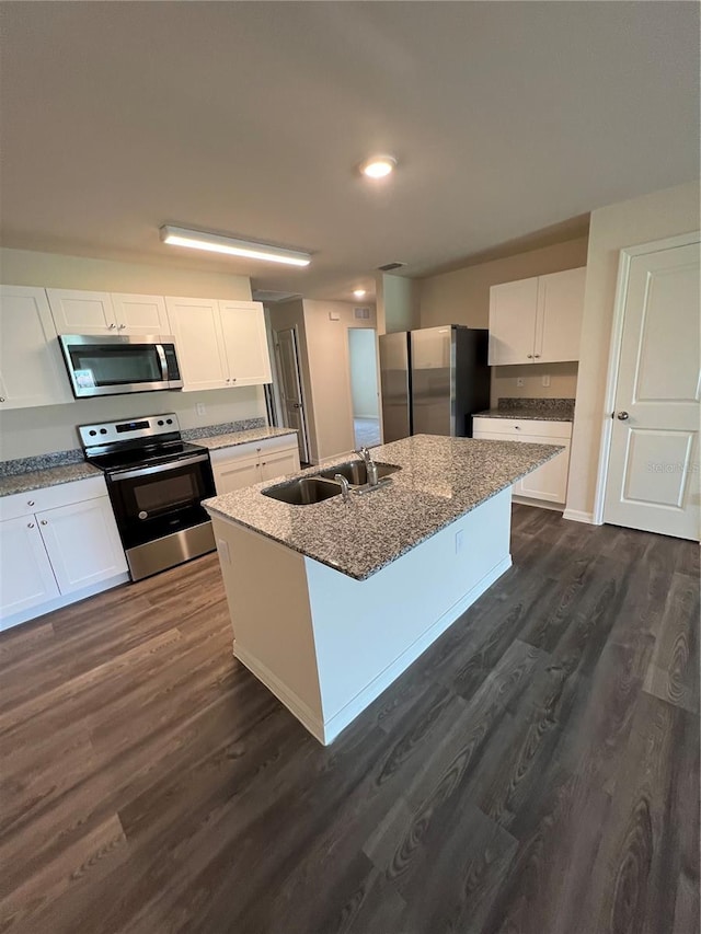 kitchen featuring appliances with stainless steel finishes, dark hardwood / wood-style flooring, a kitchen island with sink, sink, and white cabinetry