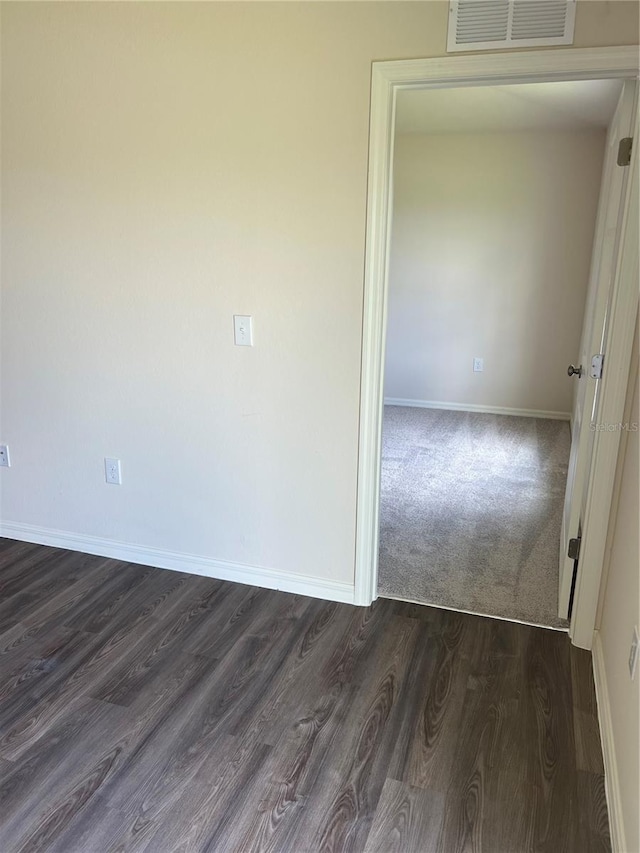 spare room featuring dark hardwood / wood-style flooring