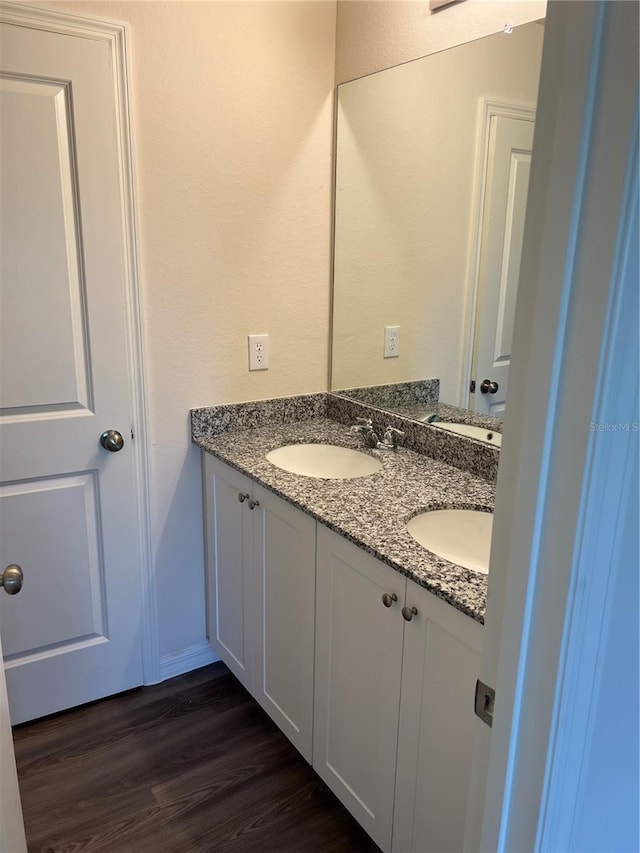 bathroom featuring vanity and wood-type flooring