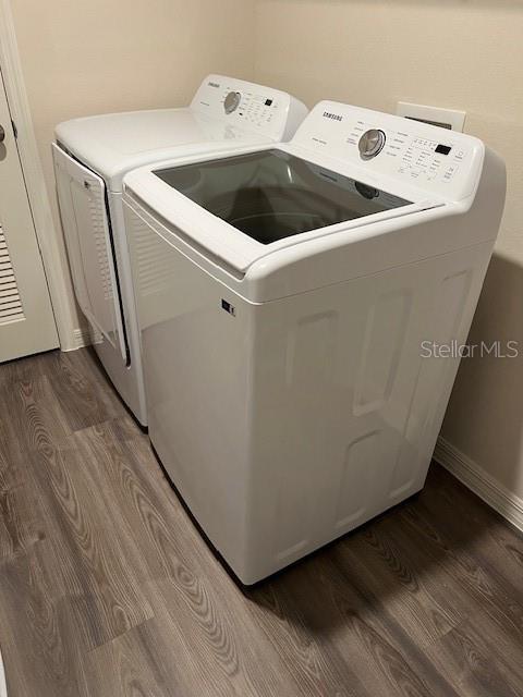 laundry room featuring washer and clothes dryer and dark hardwood / wood-style floors