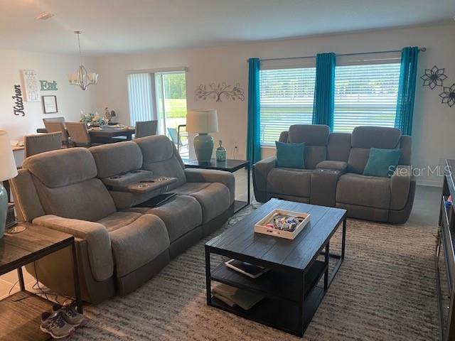 living room featuring a notable chandelier