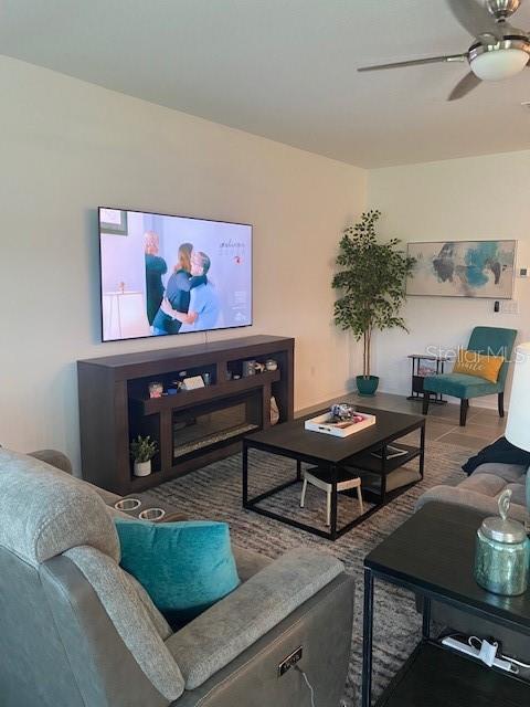 living room featuring hardwood / wood-style flooring and ceiling fan